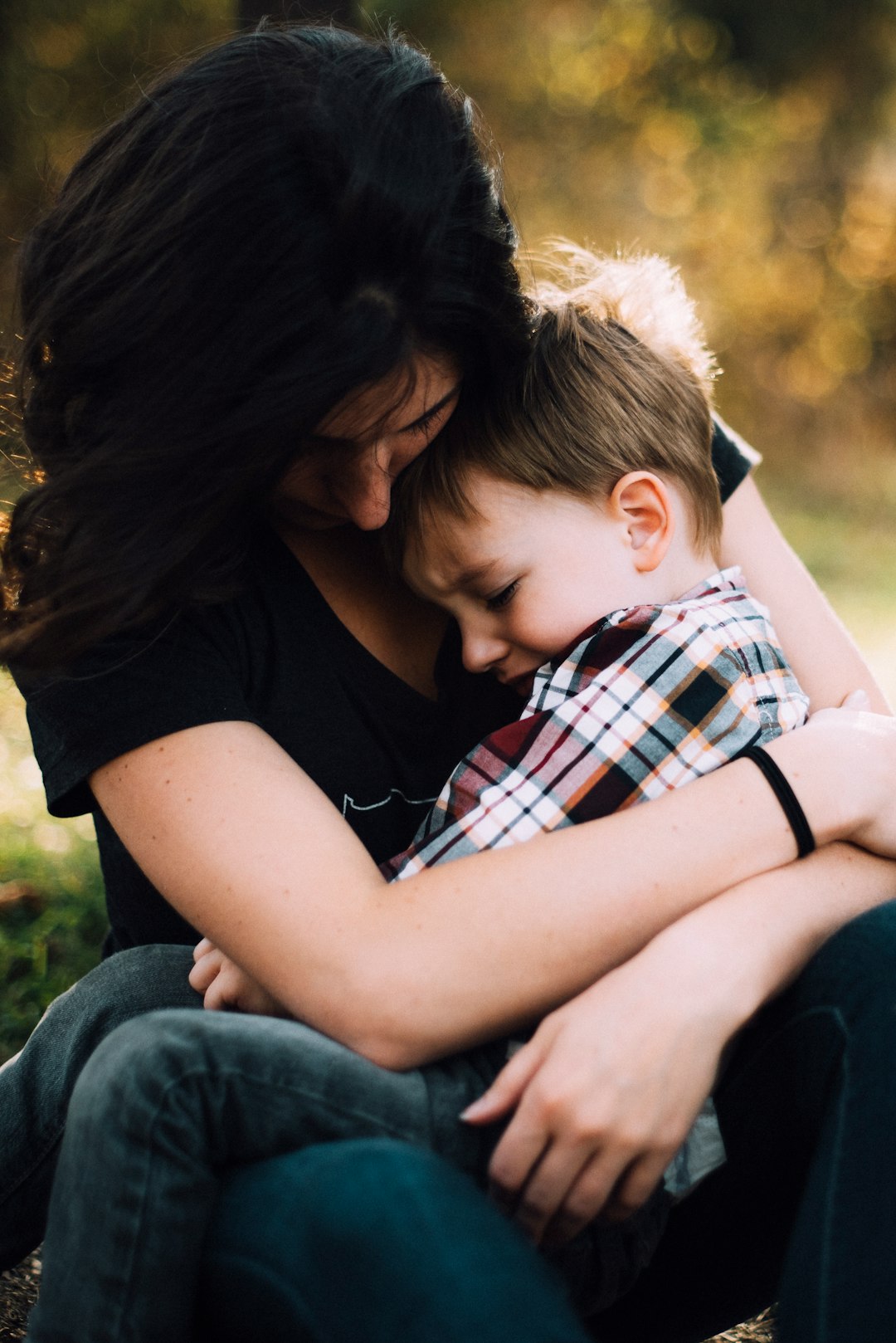 During a family vacation to the Smoky Mountains our son had a challenging moment.. but he sought and found comfort in the arms of his mom. by Florida Getaways woman hugging boy on her lap